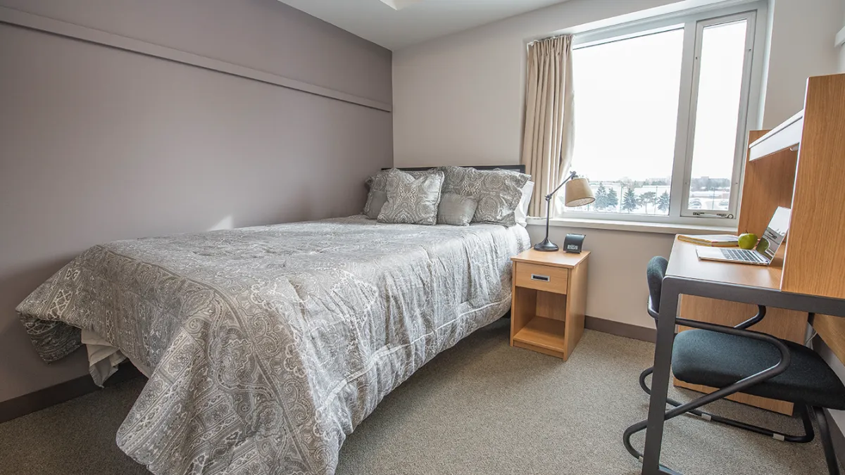 Ontario Hall Suite Bedroom showing bed, desk and window
